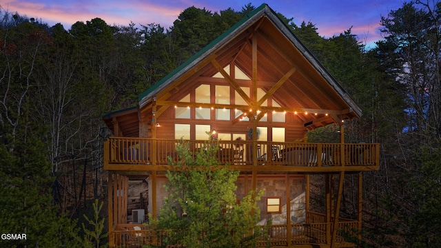 property exterior at dusk with a deck