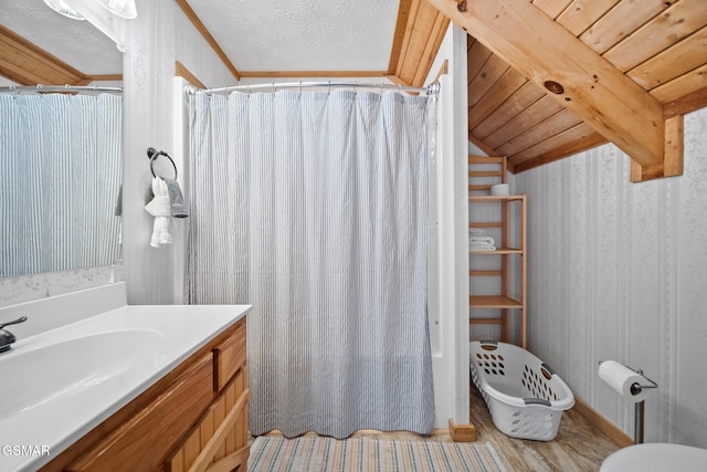 bathroom with vanity, a shower with shower curtain, vaulted ceiling with beams, wood-type flooring, and wood ceiling