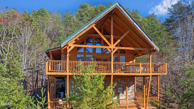 back of property featuring a wooden deck