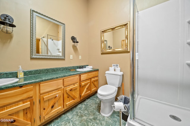 bathroom featuring vanity, toilet, and an enclosed shower