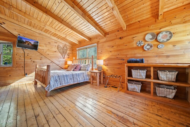 bedroom with vaulted ceiling with beams, wooden walls, wood ceiling, and wood-type flooring