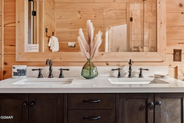 bathroom featuring a sink and double vanity