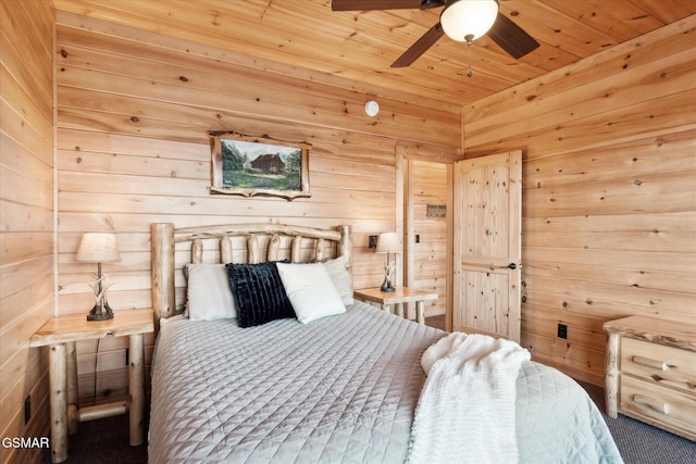 carpeted bedroom with a ceiling fan, wooden ceiling, and wooden walls