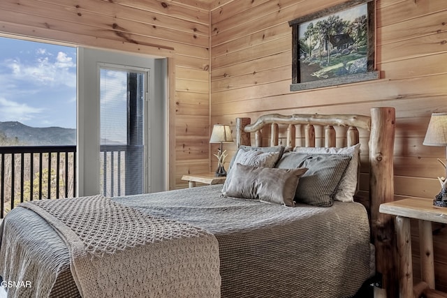 bedroom with a mountain view and wooden walls