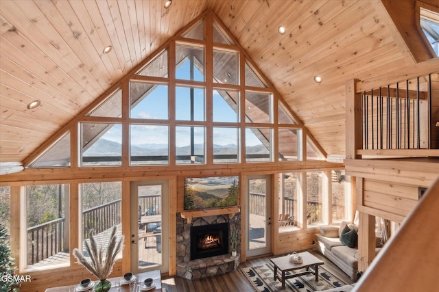 unfurnished living room with french doors, a fireplace, wood finished floors, high vaulted ceiling, and wooden ceiling