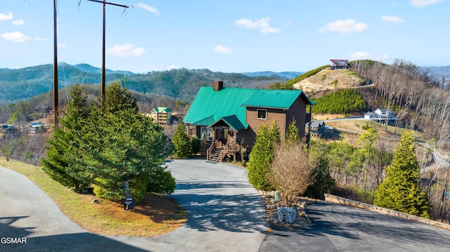 view of road with driveway and a mountain view