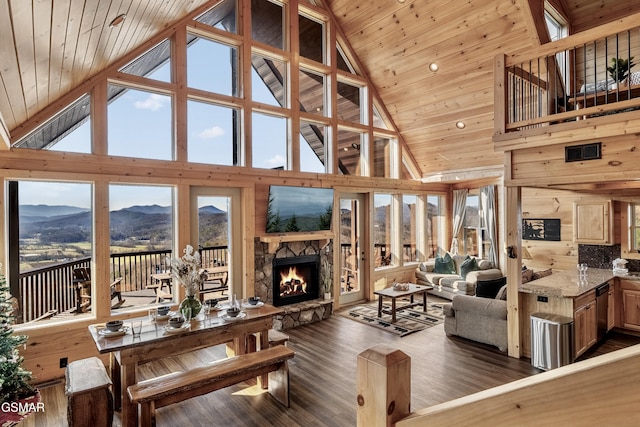 living room with lofted ceiling, wood ceiling, a fireplace, and wood finished floors