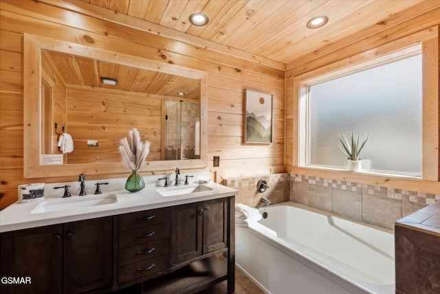 bathroom with wood ceiling, a garden tub, a sink, and double vanity