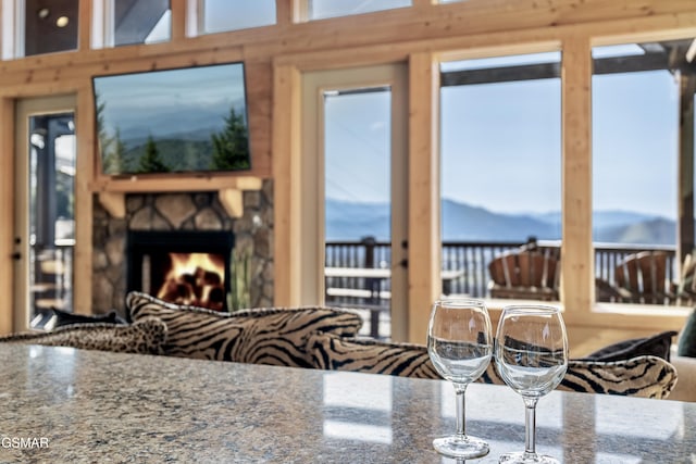 kitchen with stone counters, a wealth of natural light, and a fireplace