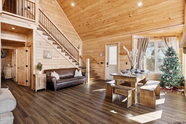 living room with stairway, wood ceiling, wood walls, wood finished floors, and high vaulted ceiling