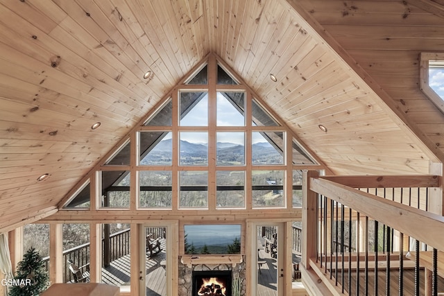 bonus room featuring high vaulted ceiling, wood ceiling, and a mountain view