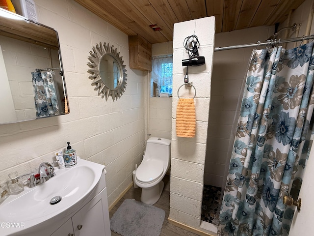 bathroom with concrete block wall, toilet, wood ceiling, a shower stall, and vanity