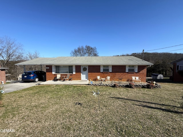 ranch-style house with a carport, concrete driveway, brick siding, and a front lawn