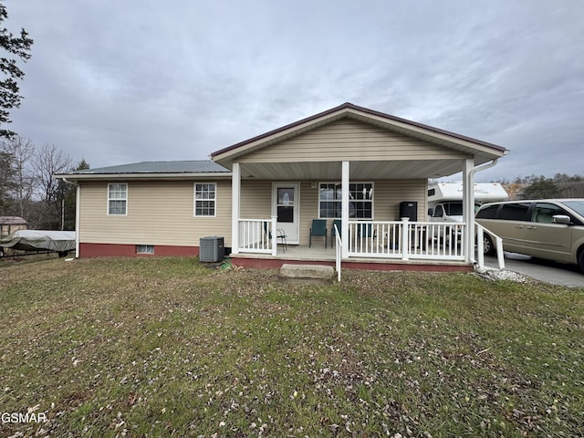 view of front facade with central AC, a front lawn, and covered porch