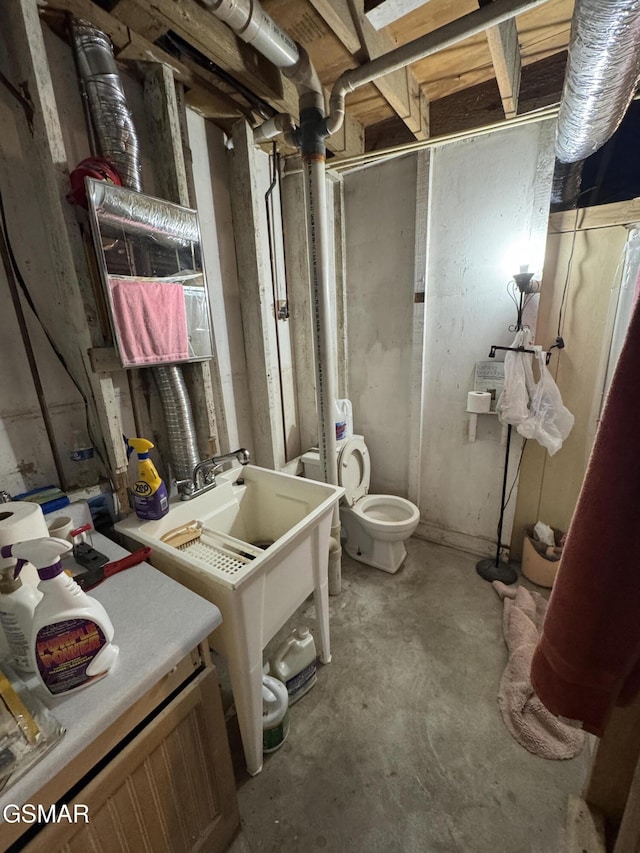 bathroom featuring concrete floors and toilet