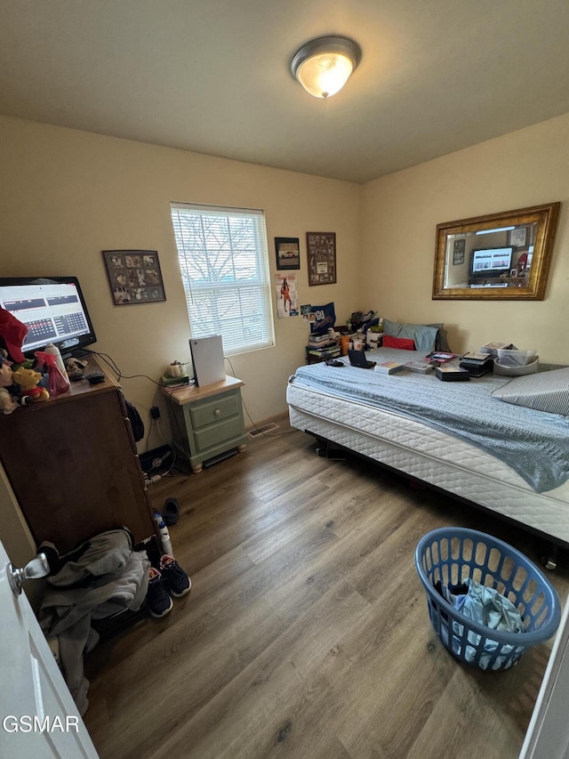 bedroom with hardwood / wood-style flooring