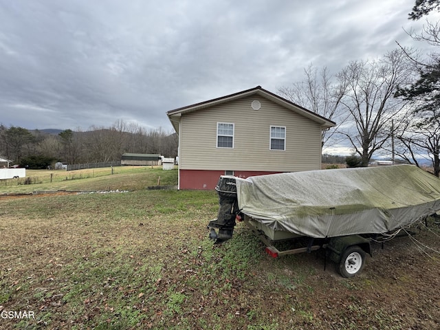 view of side of property with a lawn