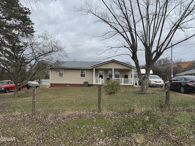 view of front of property featuring a front lawn, covered porch, and central AC unit