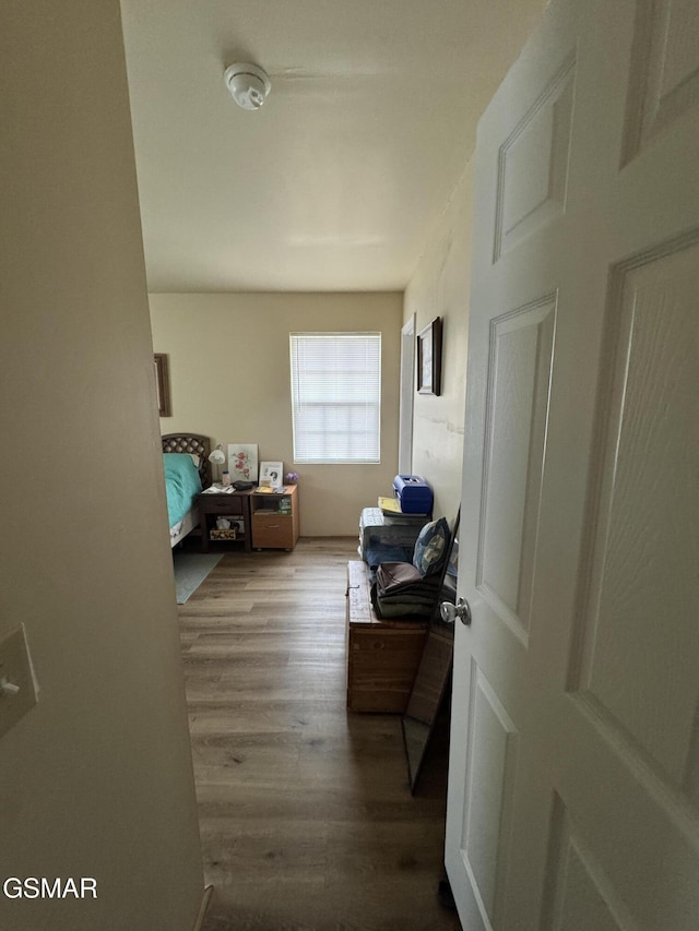 hallway with hardwood / wood-style flooring