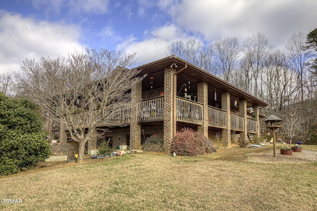 rear view of property with a deck and a lawn