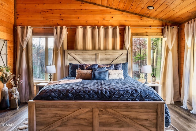 bedroom featuring wood-type flooring and multiple windows