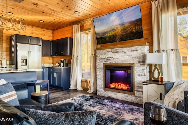 living room featuring a stone fireplace, wooden walls, dark hardwood / wood-style flooring, and wood ceiling