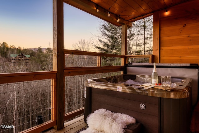 sunroom / solarium featuring a jacuzzi and wooden ceiling