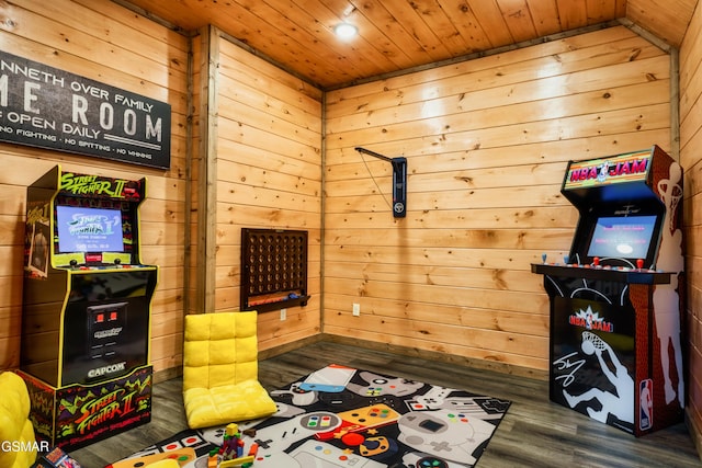 game room featuring dark hardwood / wood-style floors, wood walls, and wooden ceiling