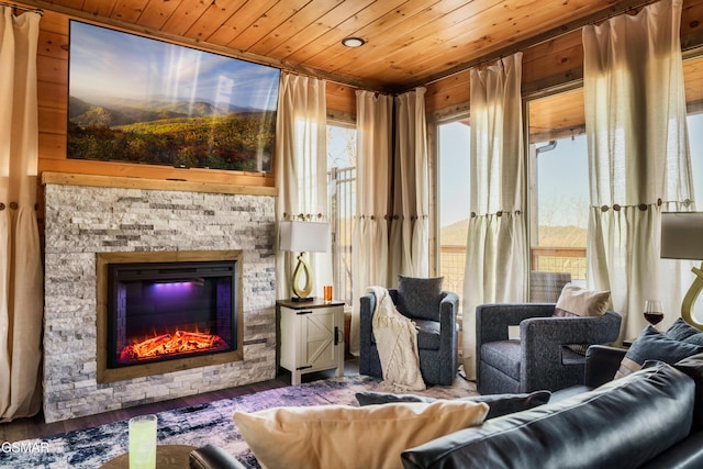 sunroom featuring a fireplace and wood ceiling