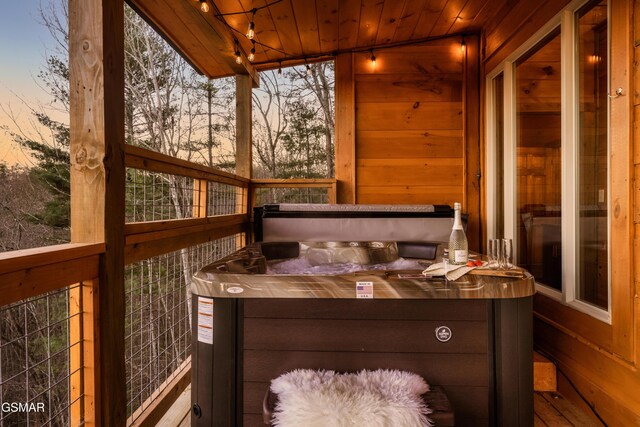 sunroom with a jacuzzi, lofted ceiling, and wooden ceiling