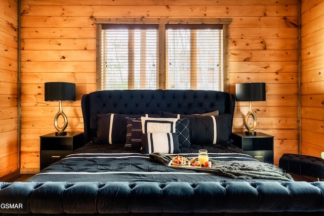 bedroom featuring wooden walls