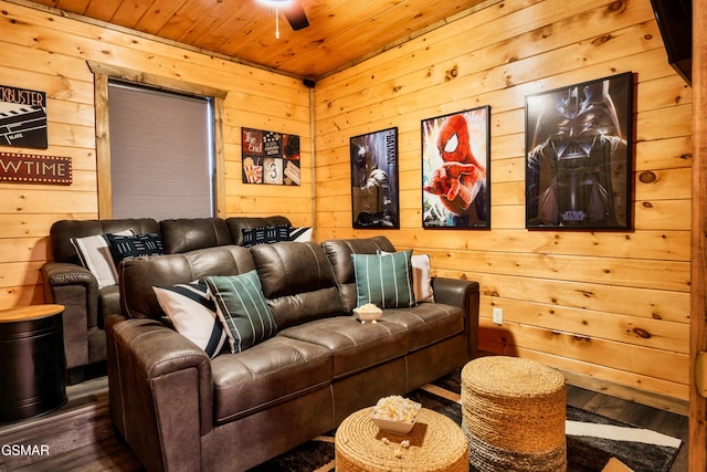 home theater featuring hardwood / wood-style floors, ceiling fan, wood ceiling, and wooden walls