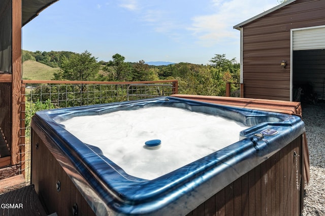 view of yard with a hot tub and a view of trees