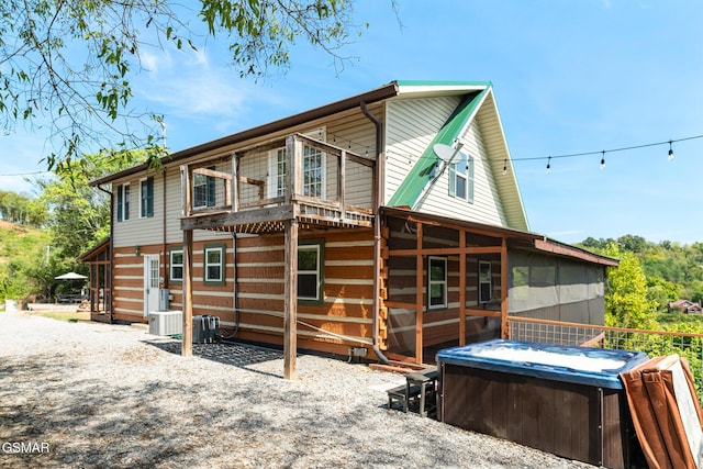 rear view of house featuring central AC unit