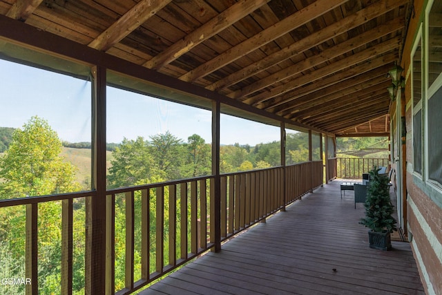 wooden deck with a view of trees