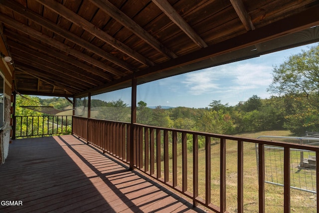 wooden deck with a view of trees
