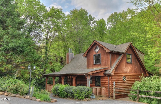 log-style house with a porch