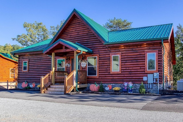 log home featuring cooling unit