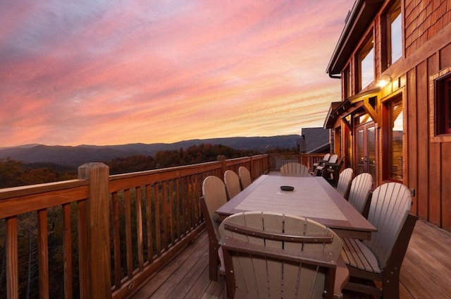 deck at dusk featuring a mountain view