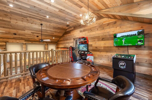 dining space with ceiling fan with notable chandelier, wood walls, wood-type flooring, and wood ceiling