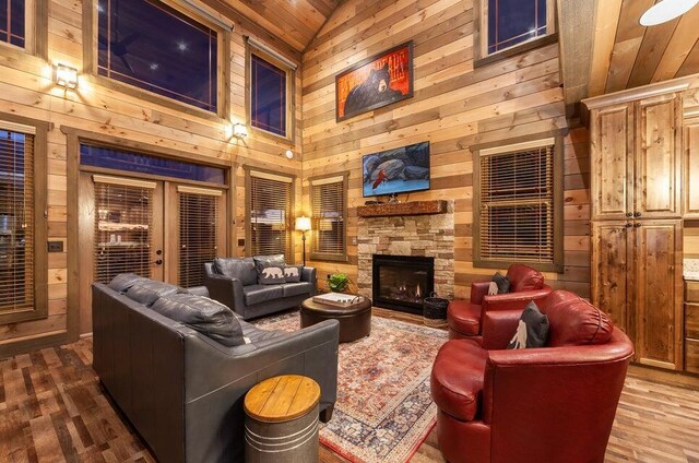 living room featuring wooden walls, a fireplace, and wooden ceiling