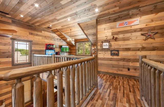 hallway with wood walls, wood-type flooring, wooden ceiling, and a notable chandelier