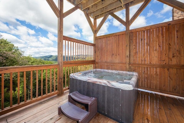 wooden terrace featuring a hot tub