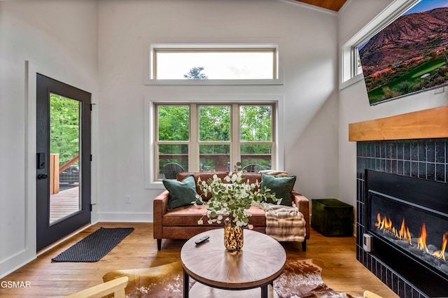 2385 Forge Hideaway Loop Unit 2, Pigeon Forge, TN 37863 - living area with a warm lit fireplace, healthy amount of natural light, wood finished floors, and a high ceiling