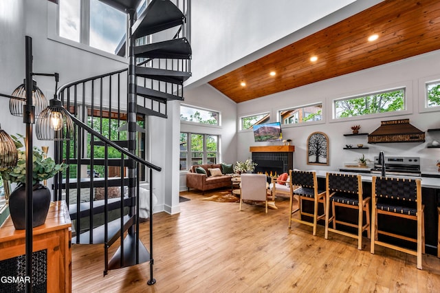 2385 Forge Hideaway Loop Unit 2, Pigeon Forge, TN 37863 - stairway featuring wood-type flooring, recessed lighting, a warm lit fireplace, wood ceiling, and high vaulted ceiling