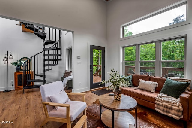 2385 Forge Hideaway Loop Unit 2, Pigeon Forge, TN 37863 - living area with stairway, wood finished floors, a high ceiling, and baseboards