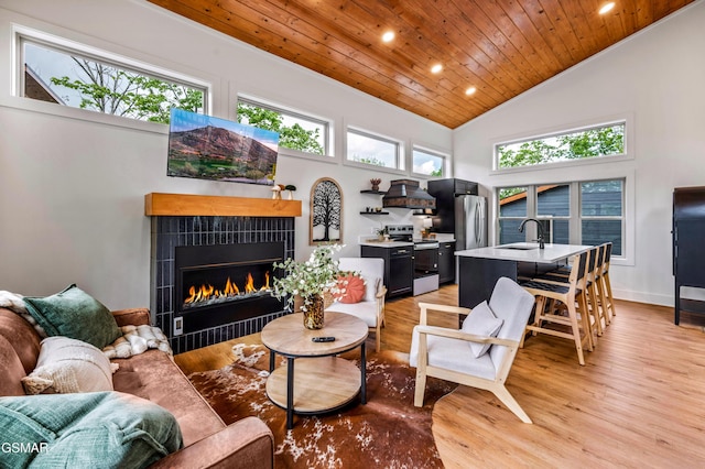 2385 Forge Hideaway Loop Unit 2, Pigeon Forge, TN 37863 - living area with wooden ceiling, recessed lighting, a tile fireplace, light wood-style floors, and high vaulted ceiling