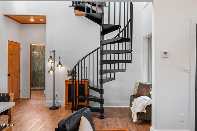 stairway featuring wood-type flooring and wood ceiling