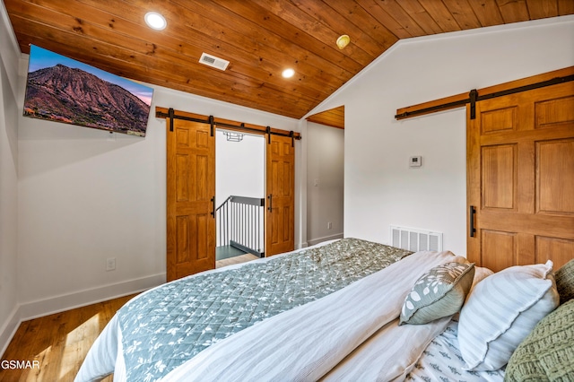 2385 Forge Hideaway Loop Unit 2, Pigeon Forge, TN 37863 - bedroom featuring a barn door, vaulted ceiling, wood finished floors, wood ceiling, and recessed lighting