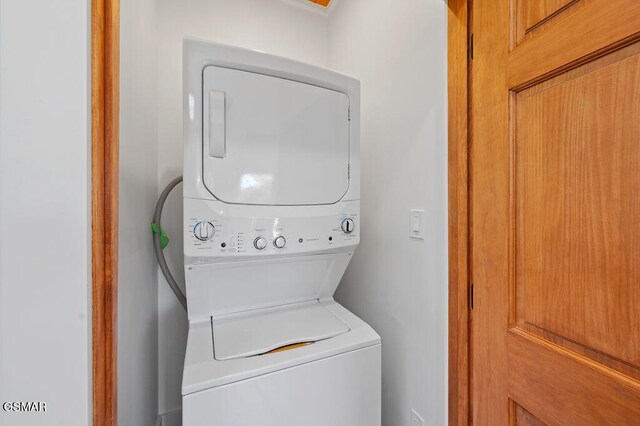 laundry room with stacked washer and clothes dryer